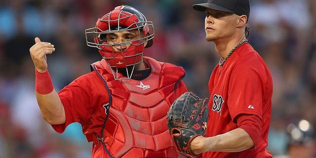 BOSTON, MA - JULY 10: Sandy Leon #3 of the Boston Red Sox signals to the dugout as Clay Buchholz #11 reacts on the mound in the fourth inning New York Yankees at Fenway Park on July 10, 2015 in Boston, Massachusetts. Buchholz left the game moments later. (Photo by Jim Rogash/Getty Images)