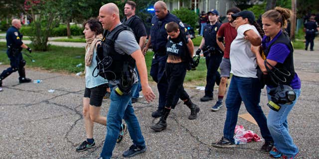 July 10, 2016: Police arrest protesters in a residential neighborhood in Baton Rouge, La.