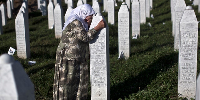 July 11, 2015: A woman weeps as she visits the grave of a family member at the Potocari memorial complex near Srebrenica, 94 miles northeast of Sarajevo, Bosnia and Herzegovina.