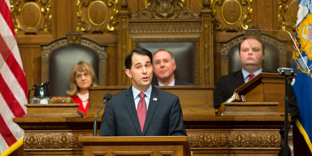 Jan. 13, 2015: Wisconsin Gov. Scott Walker, center, addresses a joint session of the state Legislature during the Governor's State of the State speech in the Assembly chambers at the state Capitol in Madison, Wis.