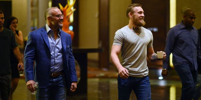 LAS VEGAS, NV - MARCH 23: UFC featherweight title challenger Conor McGregor of Ireland (R) walks with UFC CEO Lorenzo Fertitta during the UFC 189 World Championship Press Tour stop at the Red Rock Casino Resort on March 23, 2015 in Las Vegas, Nevada. (Photo by Jeff Bottari/Zuffa LLC/Zuffa LLC via Getty Images)