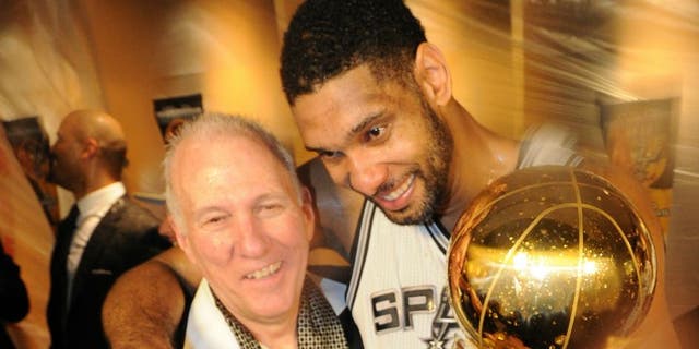 SAN ANTONIO, TX - JUNE 15: Tim Duncan #21 and Head Coach Gregg Popovich of the San Antonio Spurs celebrates after winning the NBA Championship against the Miami Heat during Game Five of the 2014 NBA Finals between the Miami Heat and San Antonio Spurs at AT&T Center on June 15, 2014 in San Antonio, Texas. NOTE TO USER: User expressly acknowledges and agrees that, by downloading and/or using this photograph, user is consenting to the terms and conditions of the Getty Images License Agreement. Mandatory Copyright Notice: Copyright 2014 NBAE (Photo by Andrew D Bernstein/NBAE via Getty Images)