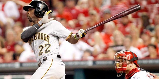 Jul 12, 2014; Cincinnati, OH, USA; Pittsburgh Pirates center fielder Andrew McCutchen (22) hits the game winning home run during the eleventh inning against the Cincinnati Reds at Great American Ball Park. The Pirates defeated the Reds 6-5. Mandatory Credit: Frank Victores-USA TODAY Sports