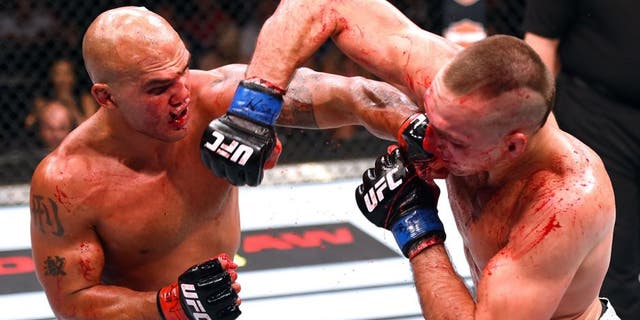 LAS VEGAS, NV - JULY 11: (L-R) Robbie Lawler punches Rory MacDonald in their UFC welterweight title fight during the UFC 189 event inside MGM Grand Garden Arena on July 11, 2015 in Las Vegas, Nevada. (Photo by Josh Hedges/Zuffa LLC/Zuffa LLC via Getty Images)