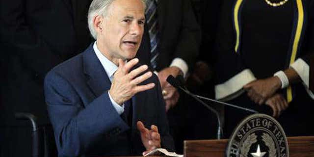 FILE - In this Friday, July 8, 2016 file photo, Texas Gov. Greg Abbott, right, responds to questions about the police shootings during a news conference at City Hall in Dallas.