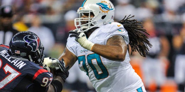 Aug 17, 2013; Houston, TX, USA; Miami Dolphins guard Dallas Thomas (70) blocks Houston Texans nose tackle Terrell McClain (97) during the game at Reliant Stadium. The Texans defeated the Dolphins 24-17. Mandatory Credit: Jerome Miron-USA TODAY Sports