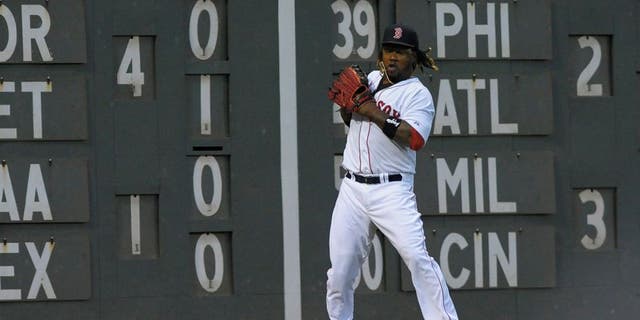 Jul 3, 2015; Boston, MA, USA; Boston Red Sox left fielder Hanley Ramirez (13) mishandles the ball during the fourth inning against the Houston Astros at Fenway Park. Mandatory Credit: Bob DeChiara-USA TODAY Sports