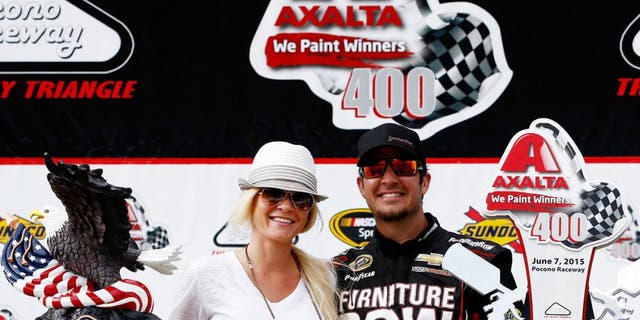 LONG POND, PA - JUNE 07: Martin Truex Jr., driver of the #78 Furniture Row/Visser Precision Chevrolet, right, and his girlfriend, Sherry Pollex, pose in Victory Lane after Truex Jr. won the NASCAR Sprint Cup Series Axalta 'We Paint Winners' 400 at Pocono Raceway on June 7, 2015 in Long Pond, Pennsylvania. (Photo by Jeff Zelevansky/NASCAR via Getty Images)