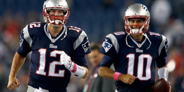 FOXBORO, MA - OCTOBER 05: Tom Brady #12 and Jimmy Garoppolo #10 of the New England Patriots warm up before a game against the Cincinnati Bengals at Gillette Stadium on October 5, 2014 in Foxboro, Massachusetts. (Photo by Jim Rogash/Getty Images)
