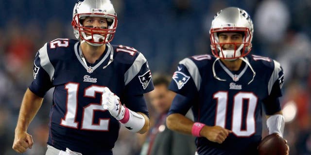 FOXBORO, MA - OCTOBER 05: Tom Brady #12 and Jimmy Garoppolo #10 of the New England Patriots warm up before a game against the Cincinnati Bengals at Gillette Stadium on October 5, 2014 in Foxboro, Massachusetts. (Photo by Jim Rogash/Getty Images)