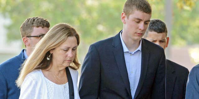 FILE - In this June 2, 2016 file photo, Brock Turner, 20, right, makes his way into the Santa Clara Superior Courthouse in Palo.