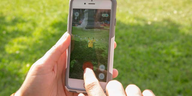 July 11, 2016: Sarah Boutwell plays the augmented-reality smartphone game Pokémon Go at the Capitol in Austin, Texas