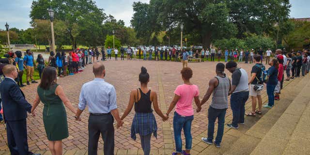 July 11, 2016: People pray during Prayer Vigil organized by Myron Smothers at Memorial Tower on the Louisiana State University campus in Baton Rouge, La.