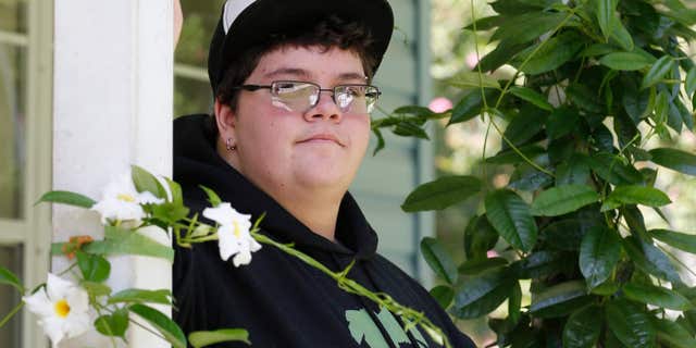 FILE - In this Aug. 25, 2015 file photo, Gavin Grimm poses on his front porch during an interview at his home in Gloucester, Va.
