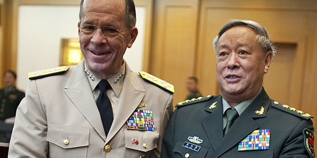 July 11: U.S. Adm. Mike Mullen, left, chairman of the Joint Chiefs of Staff, shakes hands with Gen. Chen Bingde, chief of the General Staff of the Chinese People's Liberation Army, before their meeting at the Bayi Building in Beijing, China.