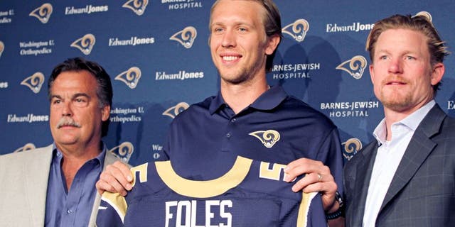 Mar 13, 2015; St. Louis, MO, USA; St. Louis Rams quarterback Nick Foles (center) is introduced to the media at Rams Park. Foles is joined by Rams head coach Jeff Fisher (left) and general manager Les Snead (right). Mandatory Credit: Billy Hurst-USA TODAY Sports