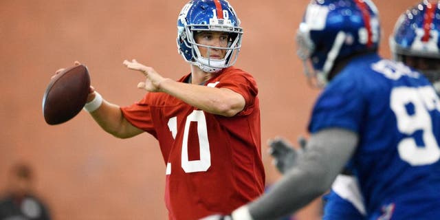 Jun 16, 2015; East Rutherford, NJ, USA; New York Giants quarterback Eli Manning (10) drops back to pass during minicamp at Quest Diagnostics Training Center. Mandatory Credit: Steven Ryan-USA TODAY Sports