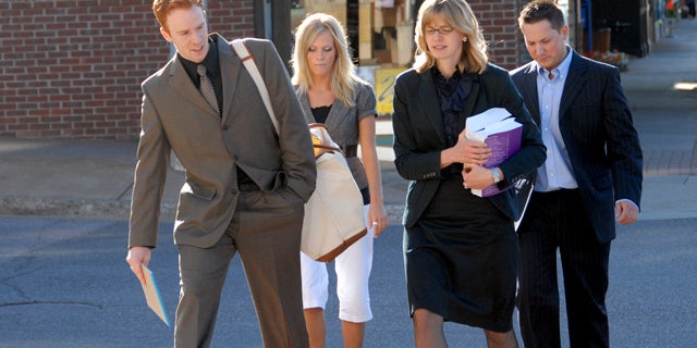 July 13: Defense attorney intern Ted Greeley, left, and lead attorney Sarah Henderson, second from right, walk with clients Allison Coss and Scott Sippola to the federal courthouse for the second day of a trial in U.S. District Court in Marquette, Mich.