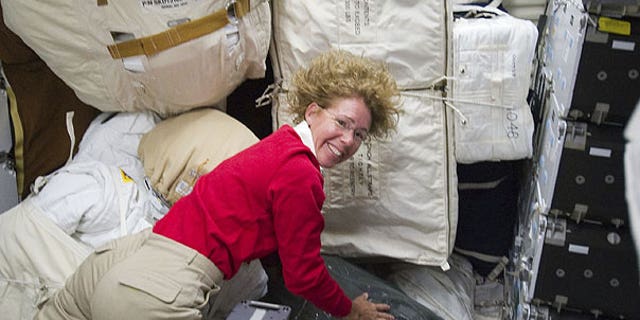 July 10: Photo provided by NASA, NASA astronaut Sandy Magnus, STS-135 mission specialist, is pictured with only a small portion of supplies and equipment on the middeck of the space shuttle Atlantis.