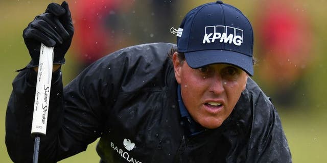 US golfer Phil Mickelson lines up a putt on the 13th green during his second round on day two of the 2016 British Open Golf Championship at Royal Troon in Scotland on July 15, 2016. The second round got underway on Friday morning, with expectations for far more trying conditions at Royal Troon. / AFP / Ben STANSALL / RESTRICTED TO EDITORIAL USE (Photo credit should read BEN STANSALL/AFP/Getty Images)