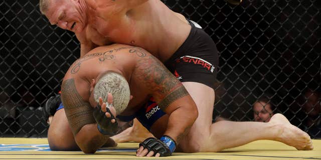 Brock Lesnar, top, fights Mark Hunt during their heavyweight mixed martial arts bout at UFC 200, Saturday, July 9, 2016, in Las Vegas.