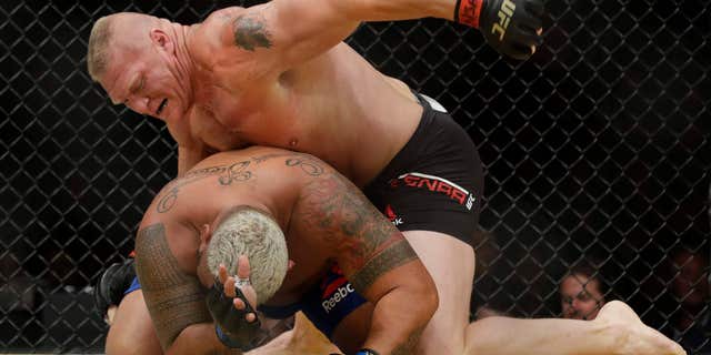 Brock Lesnar, top, fights Mark Hunt during their heavyweight mixed martial arts bout at UFC 200, Saturday, July 9, 2016, in Las Vegas.