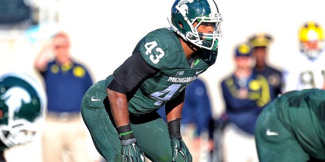 Oct 25, 2014; East Lansing, MI, USA; Michigan State Spartans linebacker Ed Davis (43) looks over the Michigan Wolverines offense during the 1st half of a game at Spartan Stadium. Mandatory Credit: Mike Carter-USA TODAY Sports