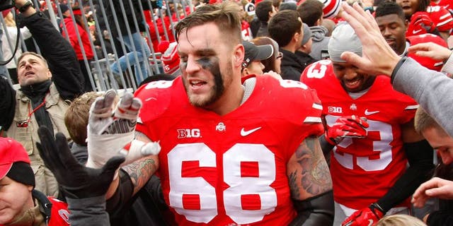 Nov 29, 2014; Columbus, OH, USA; Ohio State Buckeyes offensive lineman Taylor Decker (68) celebrates with fans following the game versus the Michigan Wolverines at Ohio Stadium. Ohio State won the game 42-28. Mandatory Credit: Joe Maiorana-USA TODAY Sports