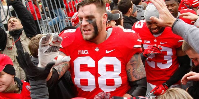 Nov 29, 2014; Columbus, OH, USA; Ohio State Buckeyes offensive lineman Taylor Decker (68) celebrates with fans following the game versus the Michigan Wolverines at Ohio Stadium. Ohio State won the game 42-28. Mandatory Credit: Joe Maiorana-USA TODAY Sports