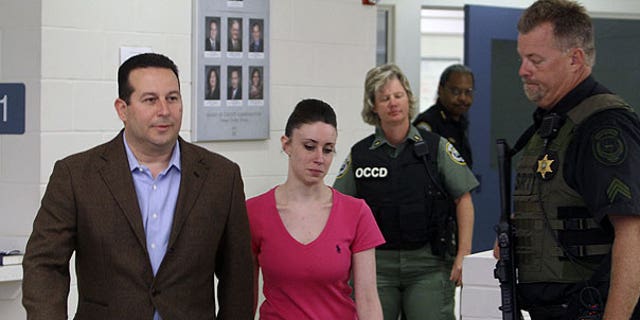 July 17: Casey Anthony, center, walks out of the Orange County Jail with her attorney Jose Baez, left, during her release in Orlando, Fla., early Sunday.