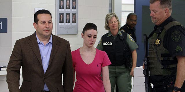 July 17: Casey Anthony, center, walks out of the Orange County Jail with her attorney Jose Baez, left, during her release in Orlando, Fla., early Sunday.