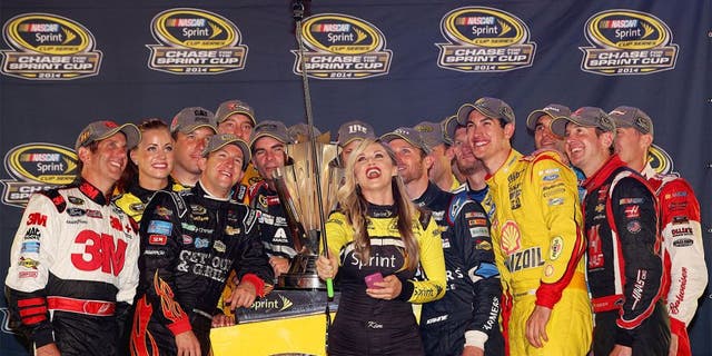 RICHMOND, VA - SEPTEMBER 06: Miss Sprint Cup Kim Coon takes a selfie with Chase for the Sprint Cup qualifiers Jeff Gordon, driver of the #24 Drive to End Hunger Chevrolet, Kyle Busch, driver of the #18 M&M's Toyota, Carl Edwards, driver of the #99 Kelloggs/Frosted Flakes Ford, Ryan Newman, driver of the #31 Catepillar Chevrolet, Miss Sprint Cup Madison Martin, Miss Sprint Cup Kim Coon, Dale Earnhardt Jr., driver of the #88 Nationwide Insurance Chevrolet, Matt Kenseth, driver of the #20 Dollar General Toyota, Aric Almirola, driver of the #43 Gwaltney Ford, Brad Keselowski, driver of the #2 Miller Lite Ford, Denny Hamlin, driver of the #11 FedEx Express Toyota, Greg Biffle, driver of the #16 3M Call Before You Dig Ford, AJ Allmendinger, driver of the #47 Bush's Beans Chevrolet, Kasey Kahne, driver of the #5 Farmers Insurance Chevrolet, Joey Logano, driver of the #22 Shell-Pennzoil Ford, Kurt Busch, driver of the #41 Haas Automation Chevrolet, and Kevin Harvick, driver of the #4 Budweiser Chevrolet, after qualifying for the Chase for the Sprint Cup during the NASCAR Sprint Cup Series Federated Auto Parts 400 at Richmond International Raceway on September 6, 2014 in Richmond, Virginia. (Photo by Chris Graythen/NASCAR via Getty Images)