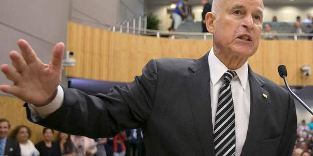 FILE - In this July 13, 2017 file photo, Calif., Gov. Jerry Brown, left, testifies in support of a pair of climate change bills as Senate President Pro Tem Kevin de Leon, D-Los Angeles, looks on during a hearing of the Senate Environmental Quality Committee, in Sacramento, Calif.