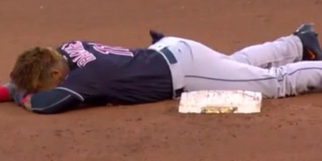 The Indians' Jose Ramirez slides face-first into second base.