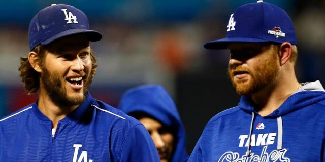 during game four of the National League Division Series at Citi Field on October 13, 2015 in New York City.,NEW YORK, NY - OCTOBER 13: Clayton Kershaw #22 and Brett Anderson #35 of the Los Angeles Dodgers smile after defeating the New York Mets in game four of the National League Division Series at Citi Field on October 13, 2015 in New York City. The Dodgers defeated the Mets with a score of 3 to 1. (Photo by Mike Stobe/Getty Images)
