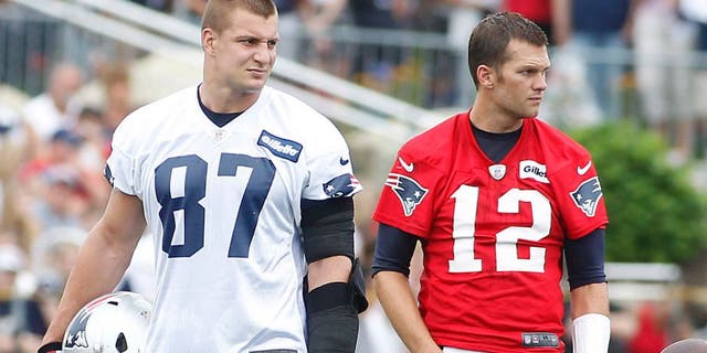 Jul 24, 2014; Foxborough, MA, USA; New England Patriots tight end Rob Gronkowski (87) and quarterback Tom Brady (12) during training camp at the team practice facility. Mandatory Credit: Stew Milne-USA TODAY Sports