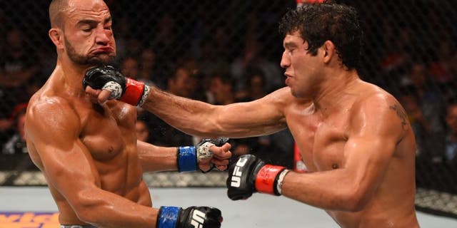 MEXICO CITY, MEXICO - JUNE 13: (R-L) Gilbert Melendez of the United States punches Eddie Alvarez of the United Statesin their lightweight bout during the UFC 188 event at the Arena Ciudad de Mexico on June 13, 2015 in Mexico City, Mexico. (Photo by Josh Hedges/Zuffa LLC/Zuffa LLC via Getty Images)