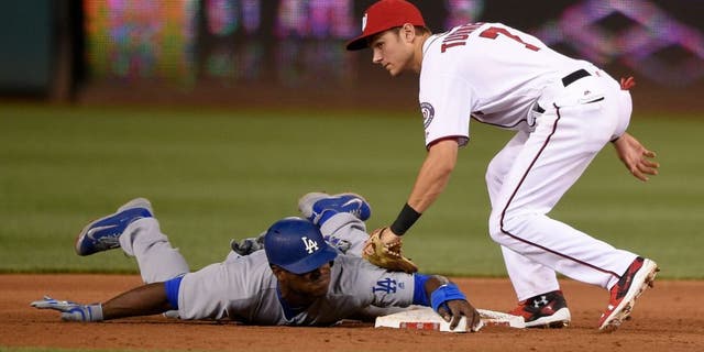 Los Angeles Dodgers' Yasiel Puig, bottom, is safe as he stole second against Washington Nationals second baseman Trea Turner (7) during the fifth inning of a baseball game, Tuesday, July 19, 2016, in Washington. The Dodgers won 8-4. (AP Photo/Nick Wass)