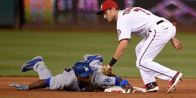 Los Angeles Dodgers' Yasiel Puig, bottom, is safe as he stole second against Washington Nationals second baseman Trea Turner (7) during the fifth inning of a baseball game, Tuesday, July 19, 2016, in Washington. The Dodgers won 8-4. (AP Photo/Nick Wass)
