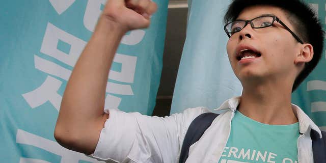 July 21, 2016: Teen protest leader Joshua Wong shouts slogans outside a magistrate's court in Hong Kong.