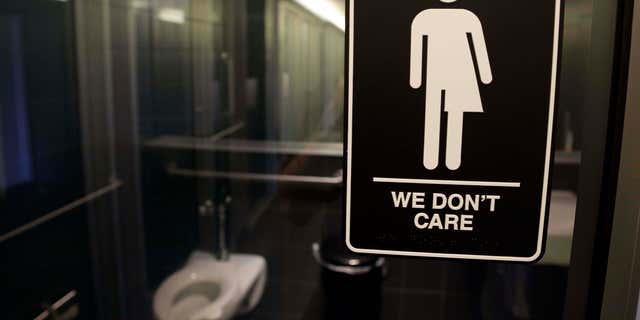 Signage is seen outside a restroom at 21c Museum Hotel in Durham, North Carolina.