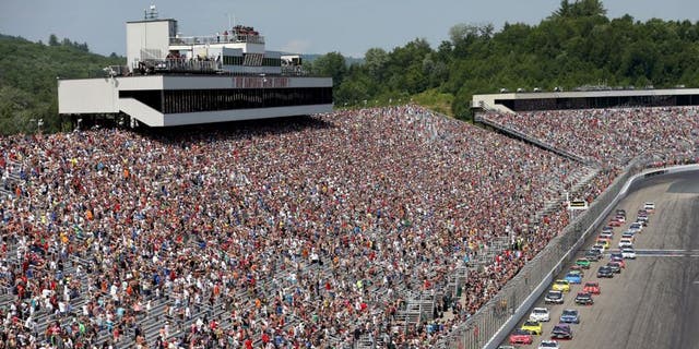 LOUDON, NH - JULY 19: Carl Edwards, driver of the #19 Sport Clips Toyota, leads the field to turn one after taking the green flag to start the NASCAR Sprint Cup Series 5-Hour ENERGY 301 at New Hampshire Motor Speedway on July 19, 2015 in Loudon, New Hampshire. (Photo by Nick Laham/Getty Images)