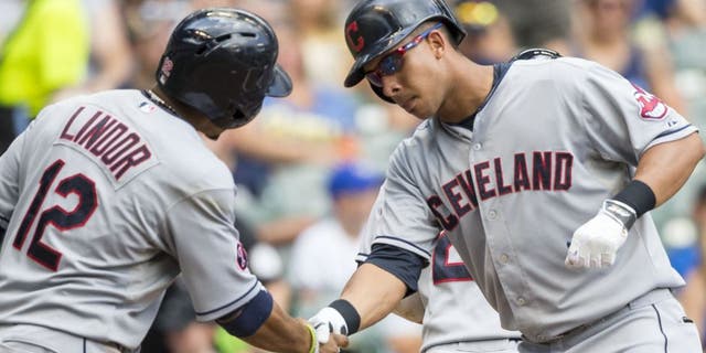 Cleveland Indians' Michael Brantley, right, shakes hands with teammate Francisco Lindor after hitting a three-run hom run off Milwaukee Brewers' Kyle Lohse during the third inning of a baseball game Wednesday, July 22, 2015, in Milwaukee.