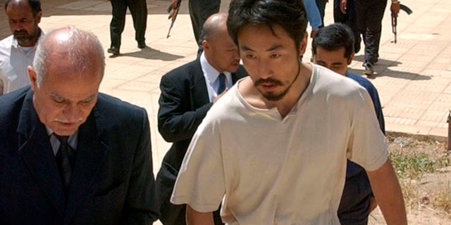 April 17, 2004: Japanese freelance journalist Jumpei Yasuda, right, is escorted after being released at Umm Al-Qura mosque in Baghdad, Iraq. Worries are growing about the whereabouts of the freelance Japanese journalist, last heard from late June, 2015, in Syria.