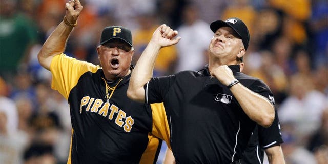 Jul 22, 2014; Pittsburgh, PA, USA; Pittsburgh Pirates manager Clint Hurdle (13) is ejected by third base umpire Jeff Nelson (45) against the Los Angeles Dodgers during the seventh inning at PNC Park. Mandatory Credit: Charles LeClaire-USA TODAY Sports