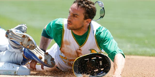 OAKLAND, CA - JUNE 27: Sam Fuld #23 of the Oakland Athletics slides safely into third, on a triple, during the game against the Kansas City Royals at O.co Coliseum on June 27, 2015 in Oakland, California. The Royals defeated the Athletics 3-2. (Photo by Michael Zagaris/Oakland Athletics/Getty Images)