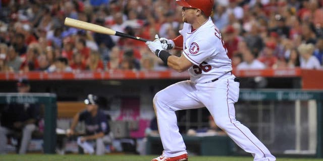July 22, 2015; Anaheim, CA, USA; Los Angeles Angels right fielder Kole Calhoun (56) hits an RBI single in the fifth inning against the Minnesota Twins at Angel Stadium of Anaheim. Mandatory Credit: Gary A. Vasquez-USA TODAY Sports
