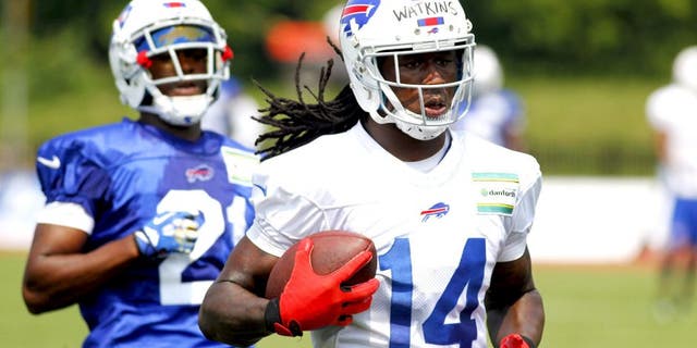 Buffalo Bills wide receiver Sammy Watkins (14) runs after a reception against corner back Leodis McKelvin (21) during their NFL football training camp in Pittsford, N.Y., Monday, July 21, 2014. (AP Photo/Bill Wippert)