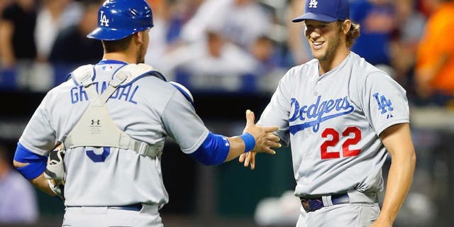 NEW YORK, NY - JULY 23: Clayton Kershaw #22 of the Los Angeles Dodgers celebrates his 3-0 shutout against the New York Mets with teammate Yasmani Grandal #9 at Citi Field on July 23, 2015 in the Flushing neighborhood of the Queens borough of New York City. (Photo by Jim McIsaac/Getty Images)