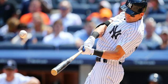 NEW YORK, NY - JULY 23: Jacoby Ellsbury #22 of the New York Yankees hits a two run double in the fifth inning against the Baltimore Orioles at Yankee Stadium on July 23, 2015 in the Bronx borough of New York City. (Photo by Mike Stobe/Getty Images)